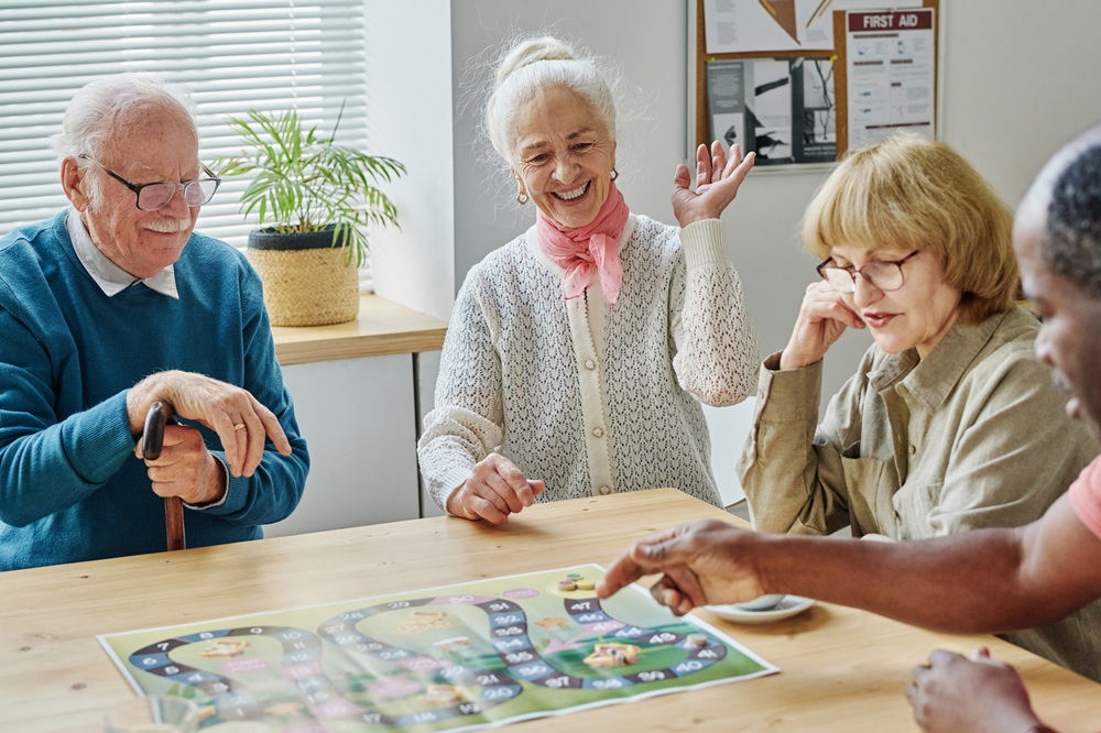 Senior people having fun playing board game